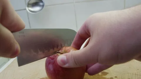 Slicing apple on a cutting board Stock Footage 286844037