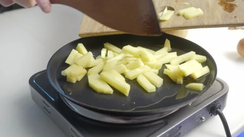 Slicing Apples Using a Modern Electric Skillet for Loving Family Meals and Stock Footage 306491564