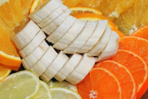 Slicing assorted banana orange lemon for the entire frame Photos