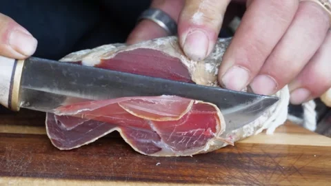 Slicing Authentic Bajona Sechee with Precision Knife Techniques Stock Footage 279902427