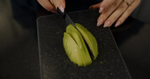 Slicing an Avocado for an Elegant Culinary Presentation That Impresses Diners Stock Footage 307311718
