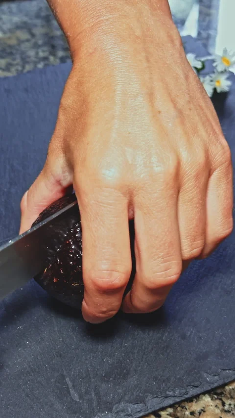 Slicing an Avocado on Slate Stock Footage 277725021