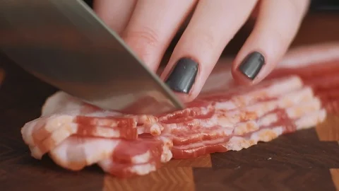 Slicing Bacon into small strips Stock Footage 85476074