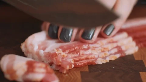 Slicing Bacon into small strips Stock Footage 85476121