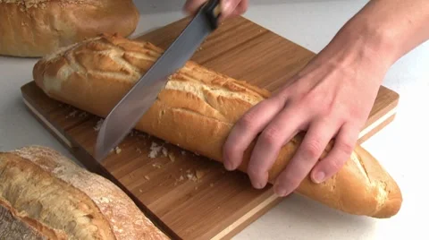 Slicing baguette Stock Footage