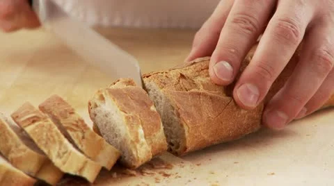 Slicing baguette Stock Footage 24637396