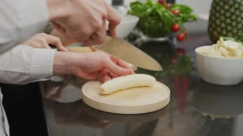 Slicing a banana Stock Footage 99941753