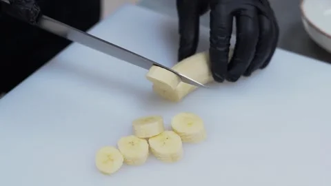 Slicing Banana in Kitchen Stock Footage 319951525