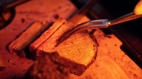 Slicing beef on a cutting board under a heat lamp Stock Footage 104665181