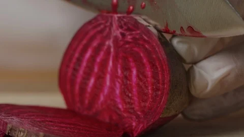 Slicing beet with chef knife macro shot, preparing ingredients for Tar Tar Stock-Footage 128490125