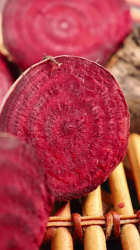 Slicing beets on a wooden table for cooking Stock Footage 337284638