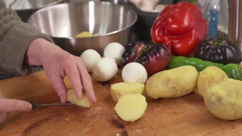 Slicing boiled potatoes on cutting board in kitchen Stock-Footage 331218551
