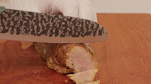 Slicing braised beef with a kitchen knife. Stock Footage 343327818