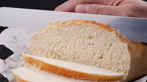 Slicing a bread, Close-up and slow motion Stock Footage 132765238