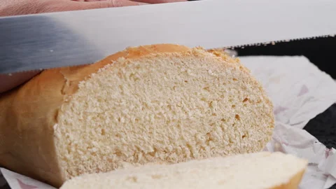 Slicing a bread, Close-up and slow motion Stock Footage 134660322