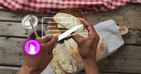 Slicing bread, hands holding knife with profile icon animation over kitchen Stock Footage 304851308
