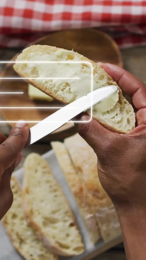 Slicing bread, hands holding knife with profile icon animation over kitchen Stock Footage 320229177