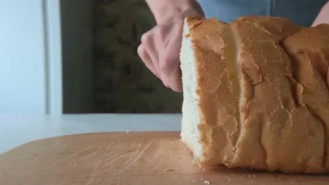 Slicing bread in the kitchen close-up. Stock Footage 170249655