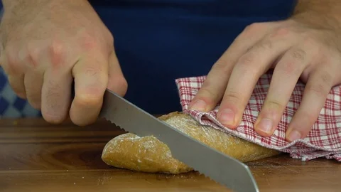 Slicing bread with a knife, ib01 Stock Footage 109130580