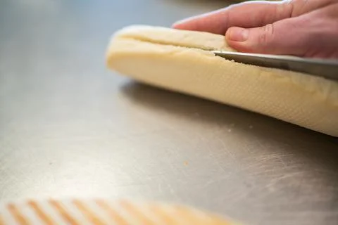Slicing bread with a sharp knive Stock Photos