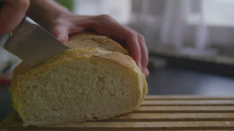 Slicing bread in slow motion Stock Footage 57638992