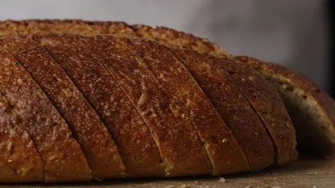 Slicing brown bread macro shot Stock Footage 128486152