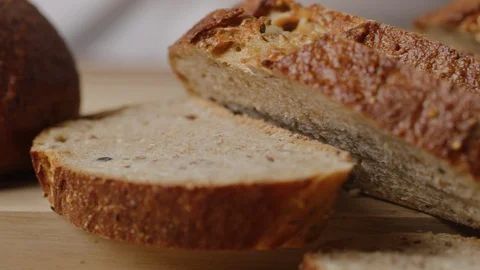 Slicing brown bread macro shot Stock Footage 128486320