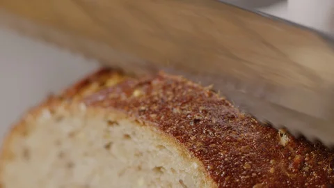 Slicing brown bread macro shot Stock Footage 128486435