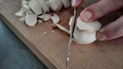 Slicing brown button mushroom stem into pieces Stock-Footage 347019998