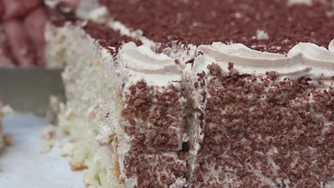 Slicing a brown cream cake close up Stock Footage 84155320