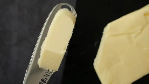Slicing butter for cooking and baking at home Stock Footage 318566716
