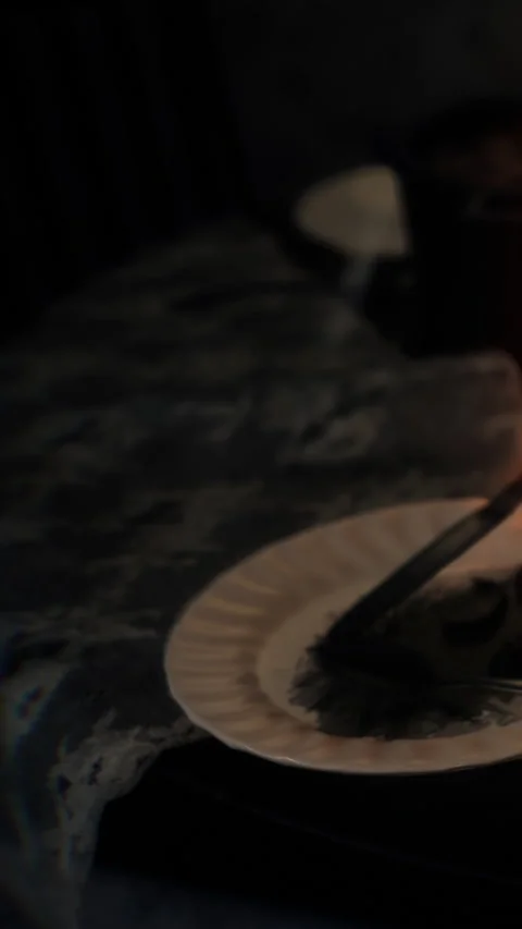 Slicing a cake during a small gathering with friends in a dim room Stock Footage 343155664