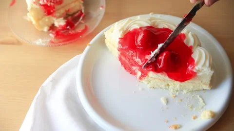 Slicing a cake with strawberry glaze Stock Footage 65796424