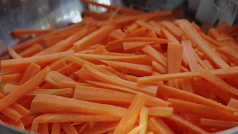 Slicing carrot close-up macro. Preparing vegetables for dishes. Food concept Stock Footage 256857708