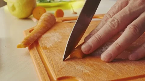 Slicing carrot closeup. Stock Footage 136651325