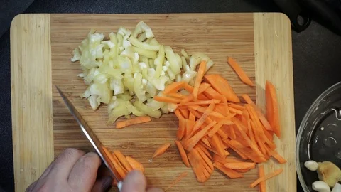 Slicing carrot overhead Stock Footage 98360632