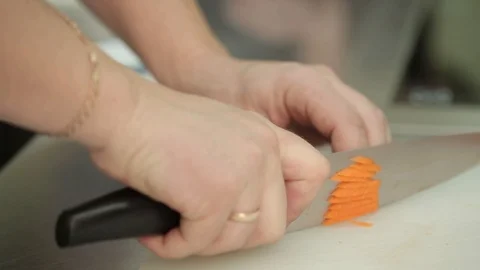 Slicing carrots by a professional chef, close-up Stock Footage 87749949