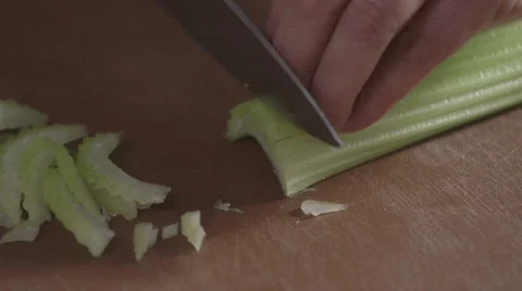 Slicing celary with a sharp knife Stock Footage 64030128