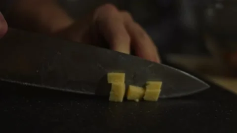 Slicing cheese into cubes a piece on a cutting board. Preparing salad of crab Stock Footage 150235422