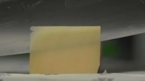 Slicing cheese with a kitchen knife. Close-up Stock Footage 102510199