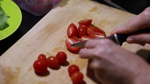 Slicing Cherry Tomatoes for a Fresh Salad Stock Footage 160140143