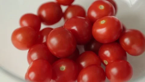 Slicing cherry tomatoes for salad. Cooking at home on a wooden Board. Stock Footage 107250652
