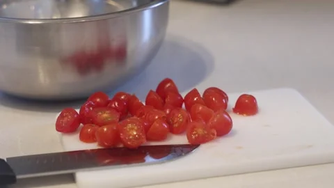 Slicing Cherry Tomatoes for Thanksgiving Dinner Salad Prep in Clean Kitchen 02 Video stock 289773454