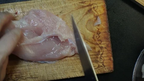 Slicing chicken overhead Stock Footage 98360794