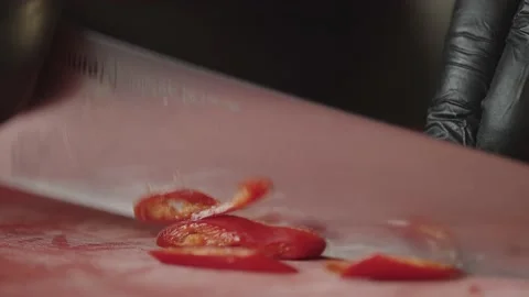 Slicing a chili pepper with a knife close-up slow motion video. Stock Footage 239270109