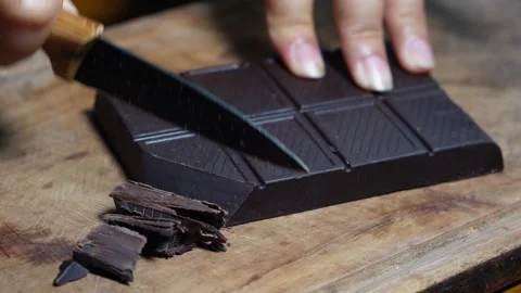 Slicing the chocolate bar with a knife Stock Footage 287681193