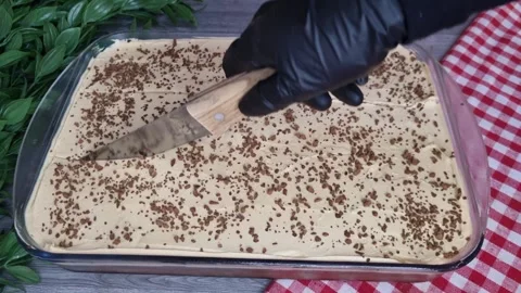 Slicing Coffee Cake in Glass Baking Dish with Spatula - Top View Stock Footage 346749141