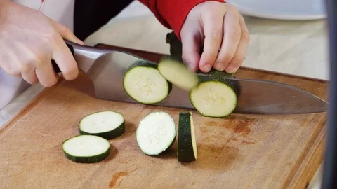 Slicing courgettes for cooking Stock Footage 105398800