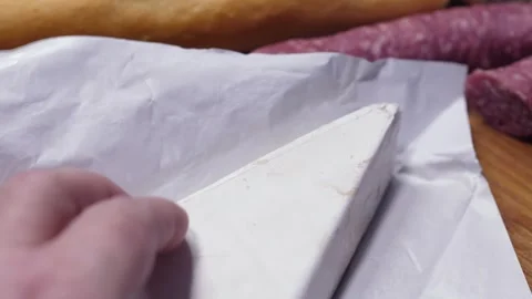 Slicing Creamy Cheese with a Sharp Knife Stockbeeldmateriaal 330693602