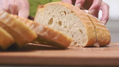 Slicing crusty white bread on cutting board. Stock Footage 150884537